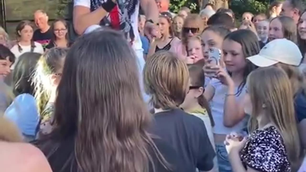 Young man gets on stage with the local rock band to jam to Guns and Roses.