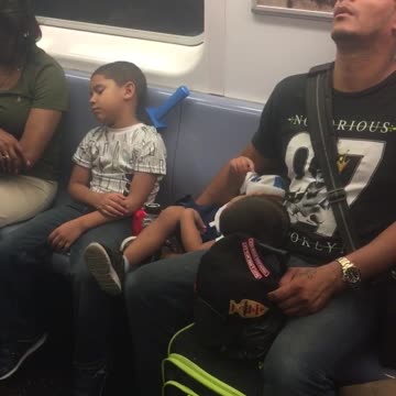 Man and boys fall asleep on train