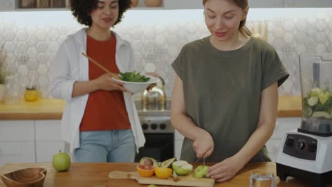 Two Woman Preparing Healthy Foods In The Kitchen