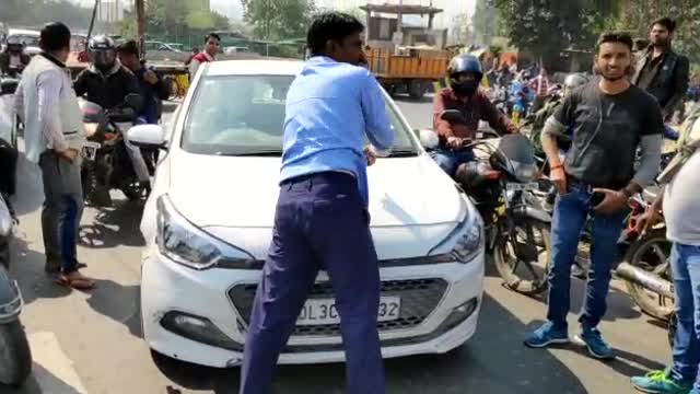 Man driven on the bonnet of a car in Ghaziabad India