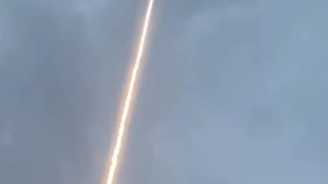 Lightning bolt is guided to ground through rocket trail