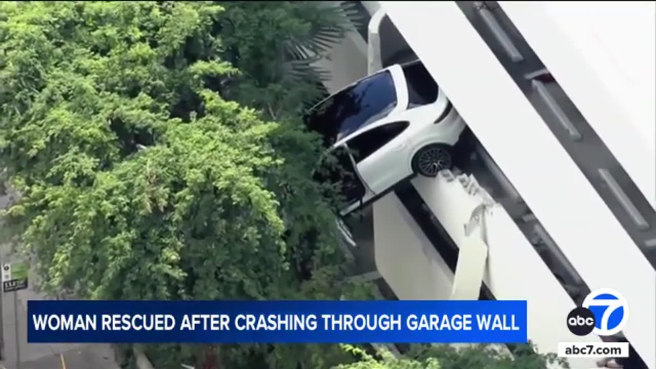 Woman slams her Porsche through parking garage wall