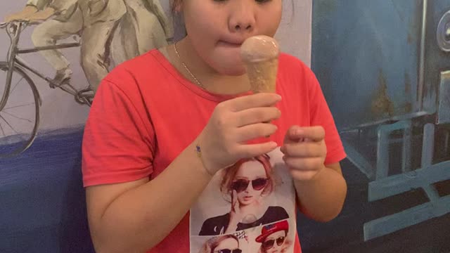 Cute little girl eating ice cream