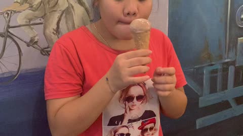 Cute little girl eating ice cream