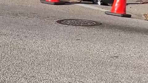 Worker Chucks a Brick From Manhole