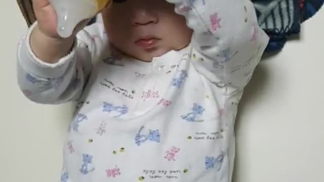 This is a video of a baby playing and playing with formula.