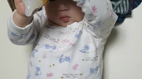 This is a video of a baby playing and playing with formula.