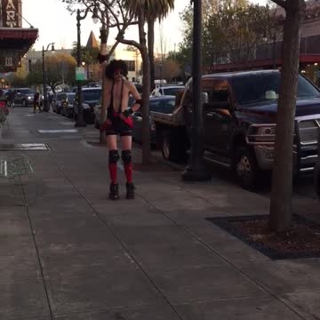 Man in red outfit skates and falls on street