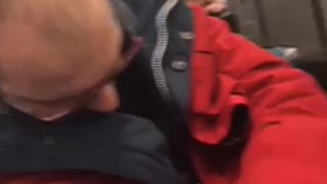 Guy black jacket grey pants yelling and singing red jacket guy sleeping