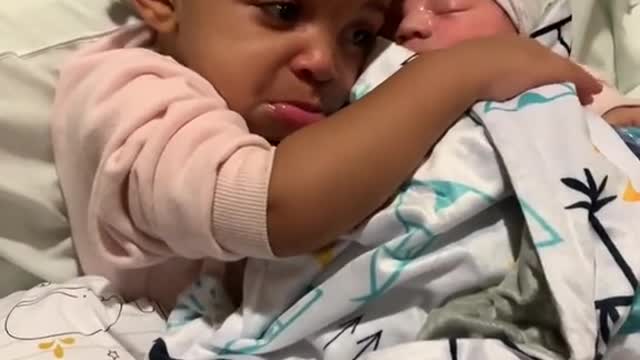 Cute baby girl crying because she thinks her baby toy died