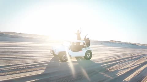 Two Vehicles Traveling In The Desert