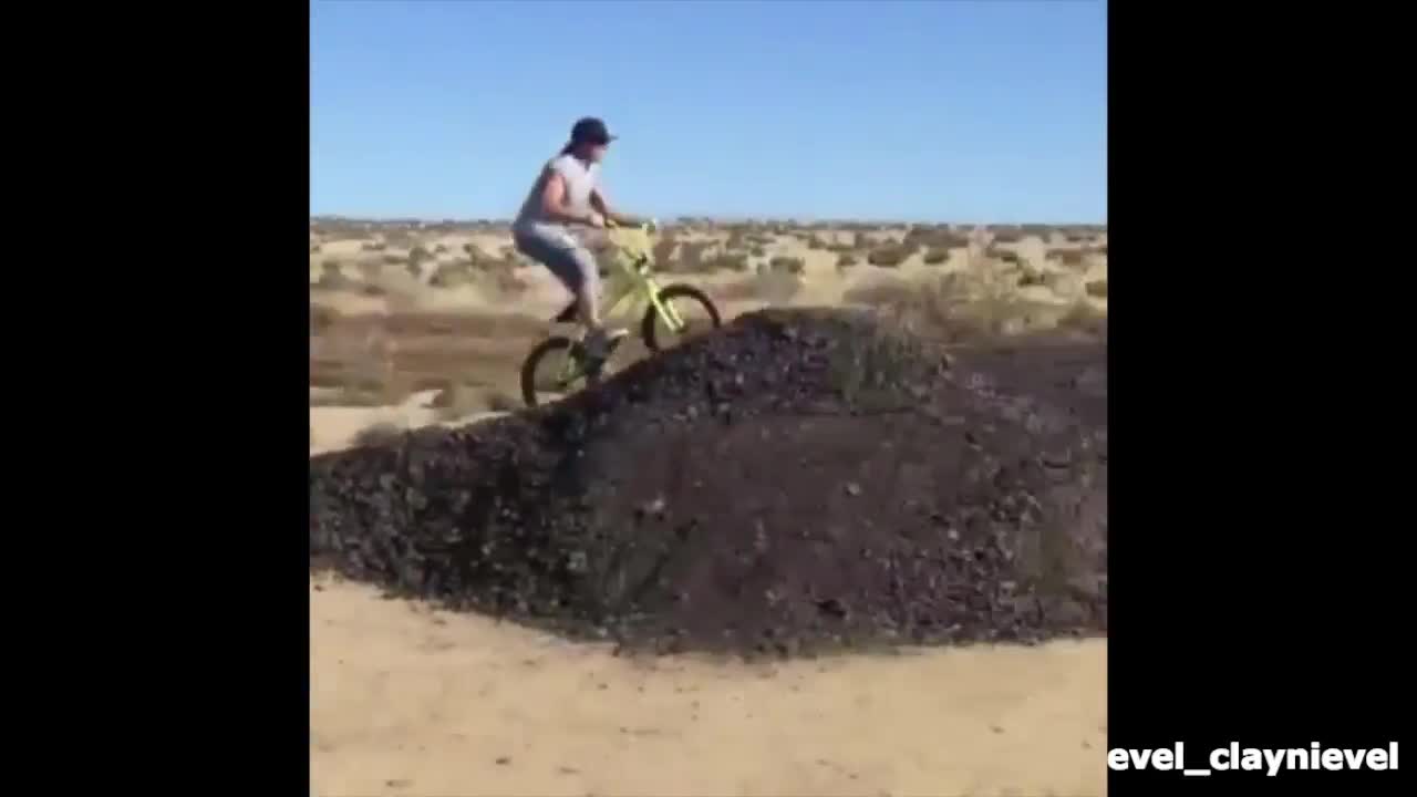 Guy neon bike dirt mound jump fail