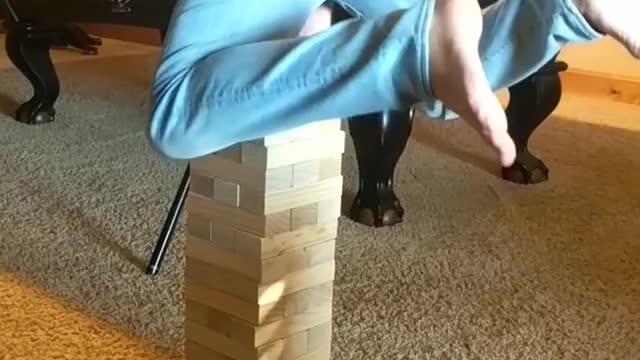Man hand stand on jenga
