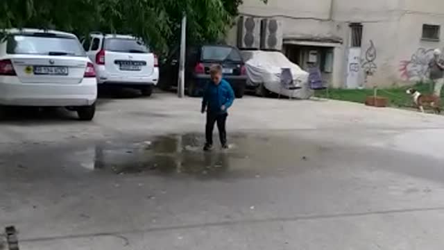 My son playing in outside after raining