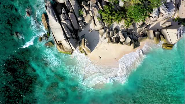 drawing a arge heart figure on the sand-of a seashore