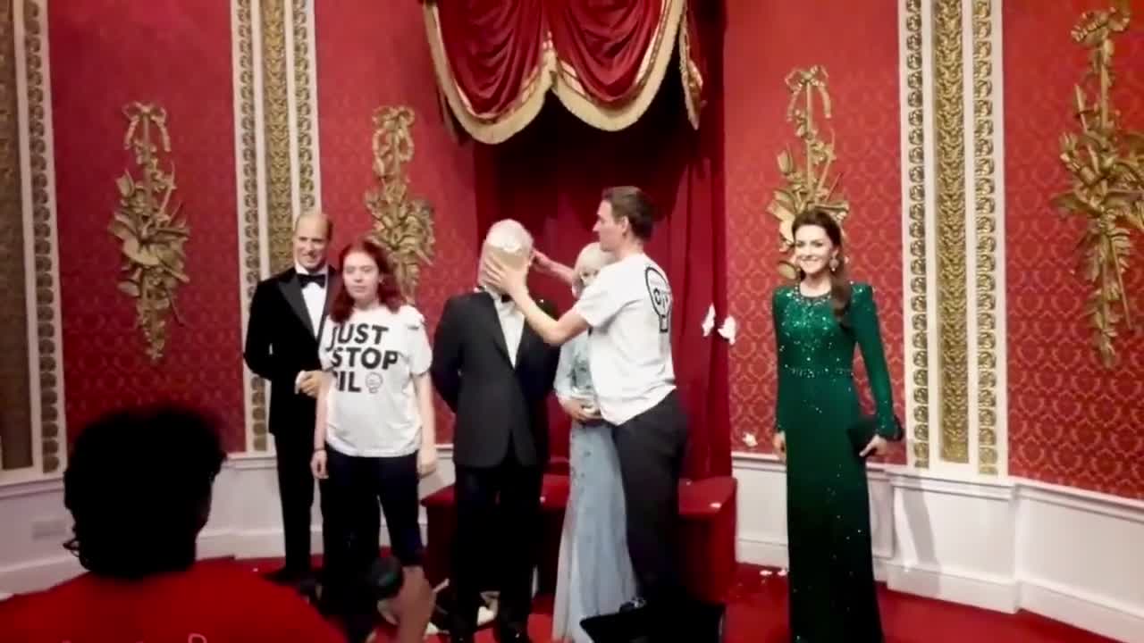 Just Stop Oil activists throwing Cake at King Charles's waxwork at London's Madame Tussauds