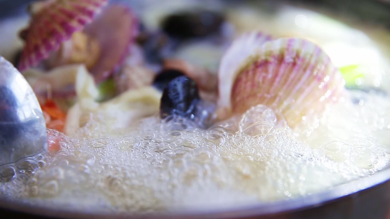 Korean-style noodle soup with seafood is boiling