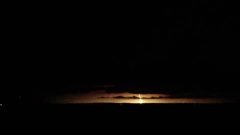 UFO hiding under storm cloud