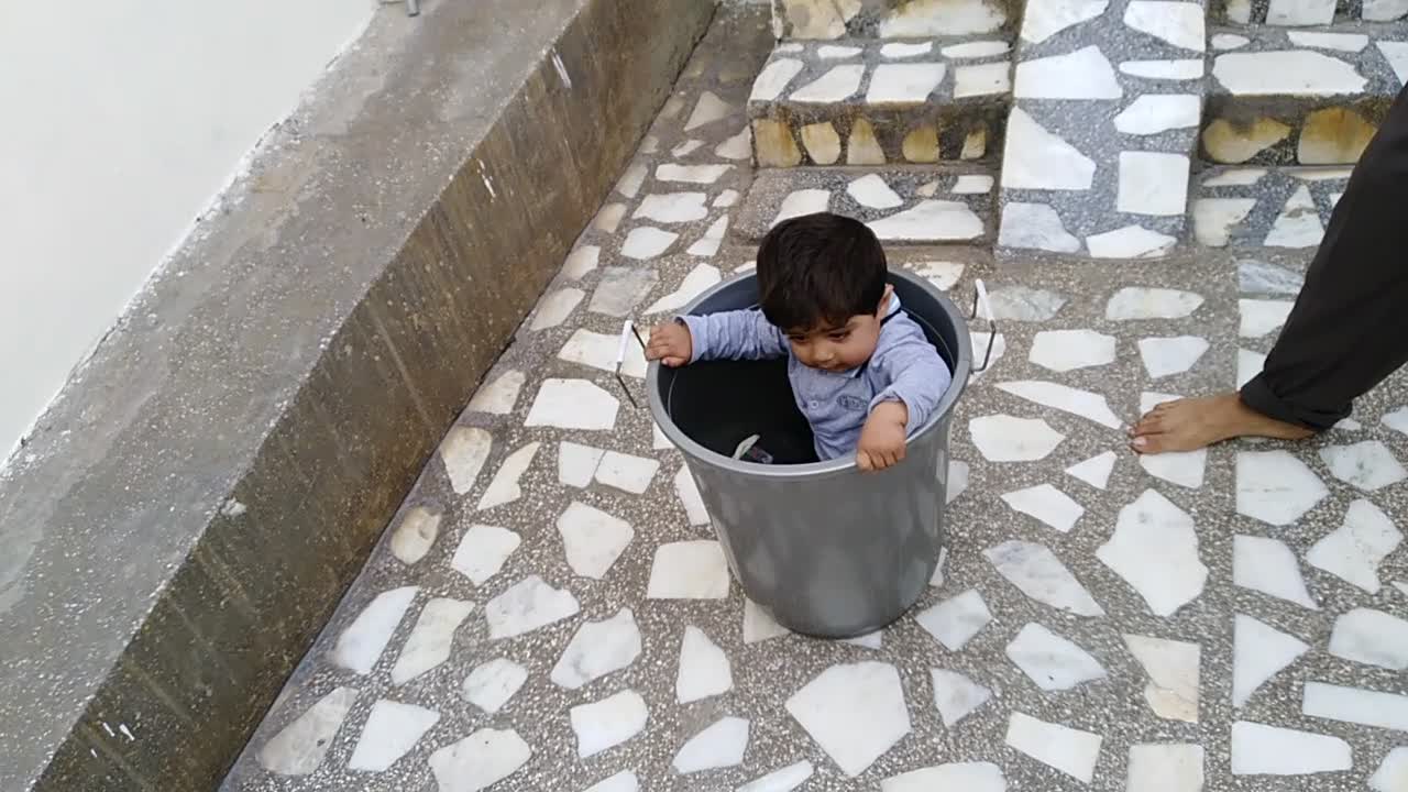 Cute kid went in bucket and came down through slide with bucket