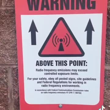 5G tower next to a school. Look at the warning signs