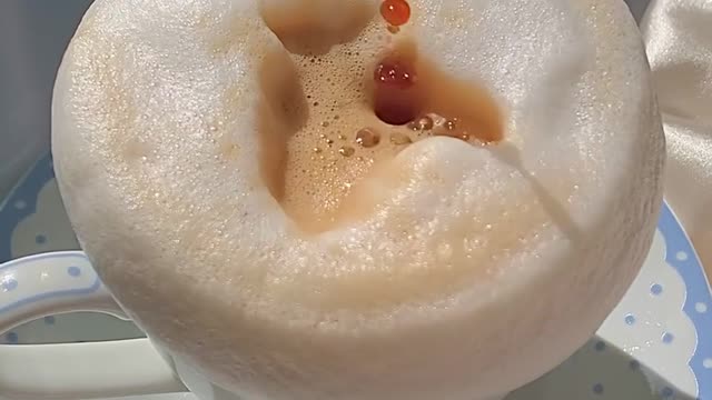 Overflowing Foam in a Coffee Cup