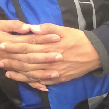 Cockroach crawling down mans blue and black backpack on subway