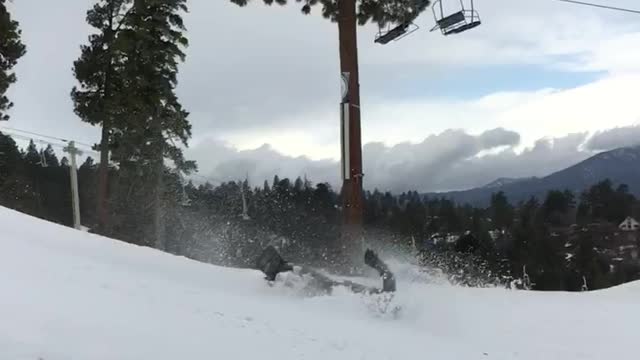 Guy in grey snow boarding lands on back