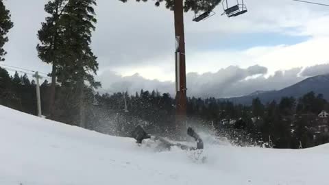 Guy in grey snow boarding lands on back