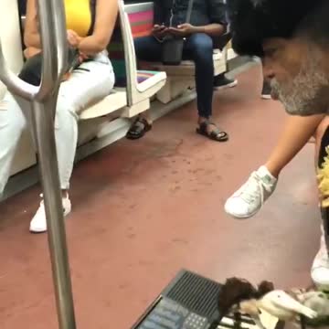 Man sings play piano and holds onto dolls
